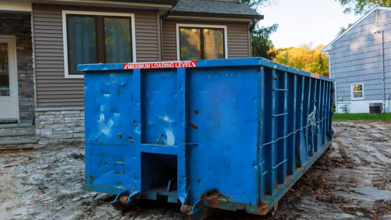 A blue dumpster bin