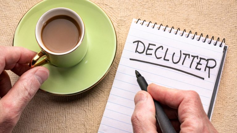 A cup of tea and a notepad that says "declutter"