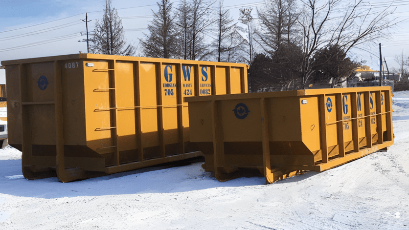 a yellow dumpsters in the snow