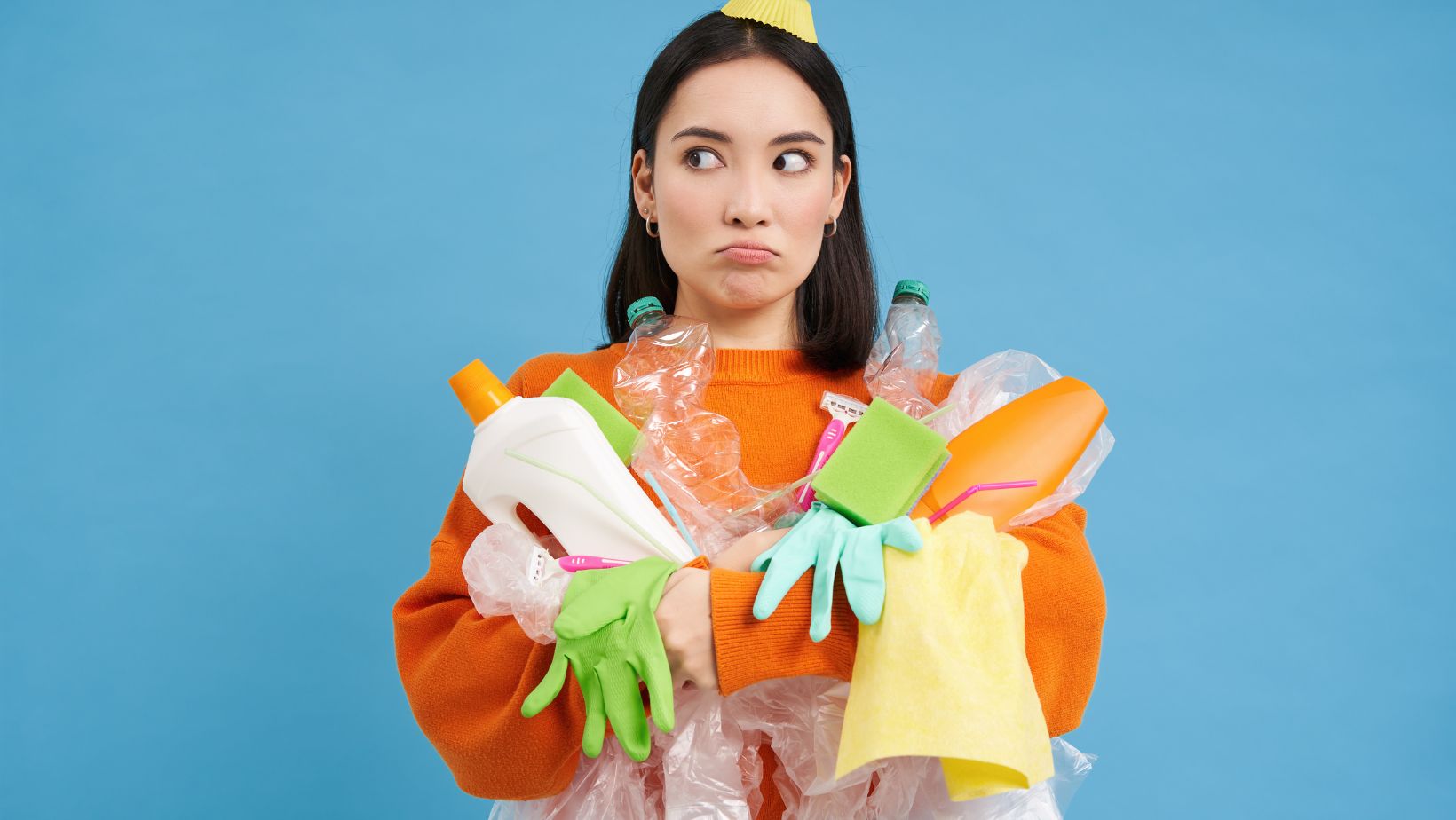 A woman holding clutter and garbage