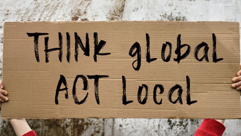 A sign that says "Think Global, Act Local"