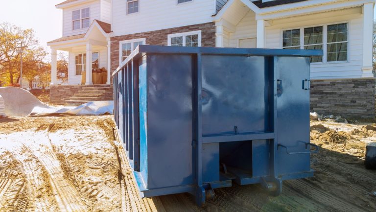 a roll off bin in front of a house