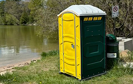 Portable toilet at a campground near a lake